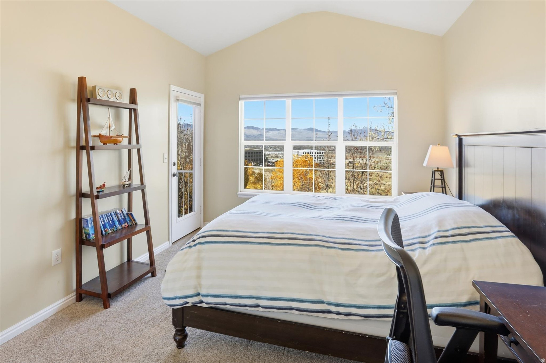 Primary bedroom with vaulted ceiling